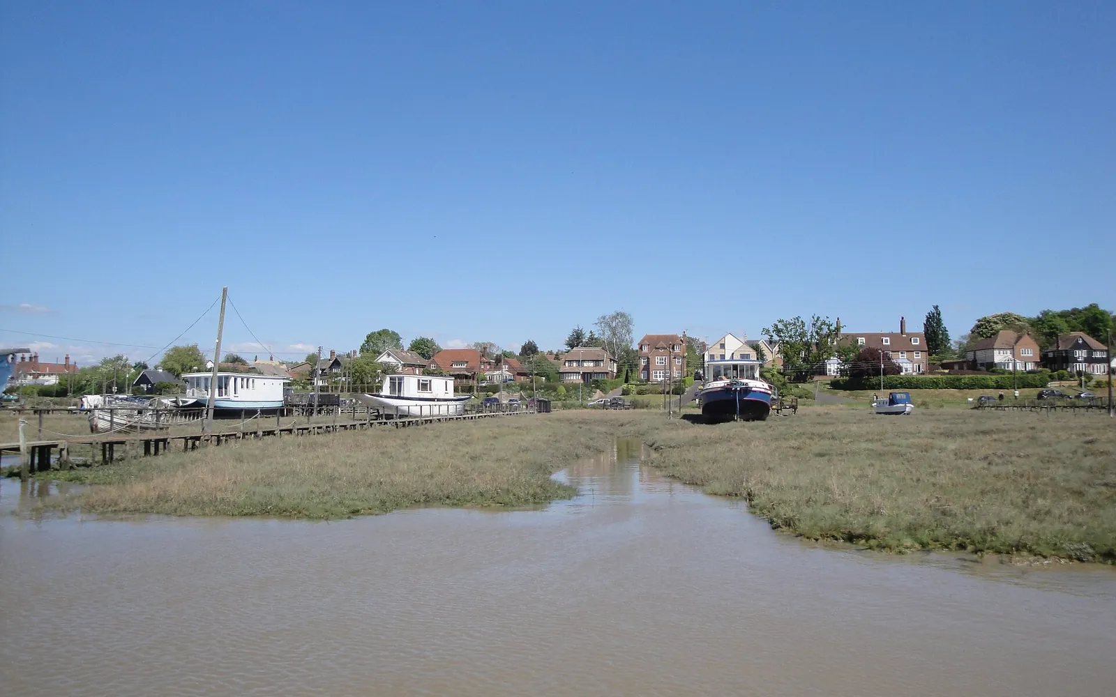 Houses on stilts beside a tidal creek in West Mersea